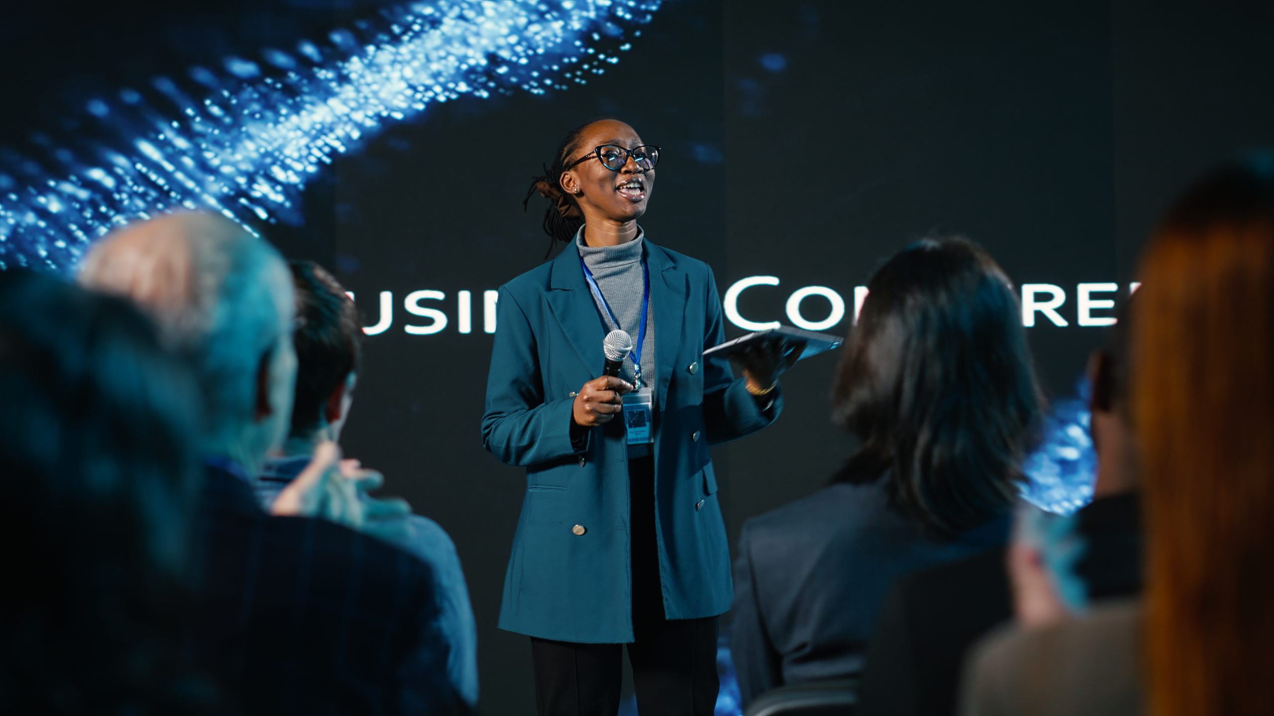 African american young adult hosting a panel discussion during business event